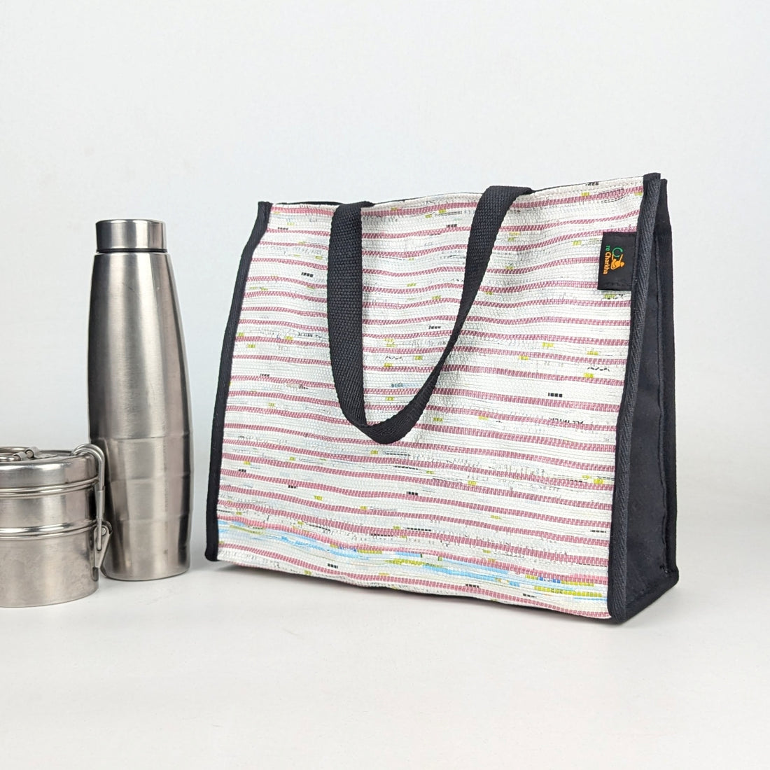 Striped lunch bag with black handles and trim,
