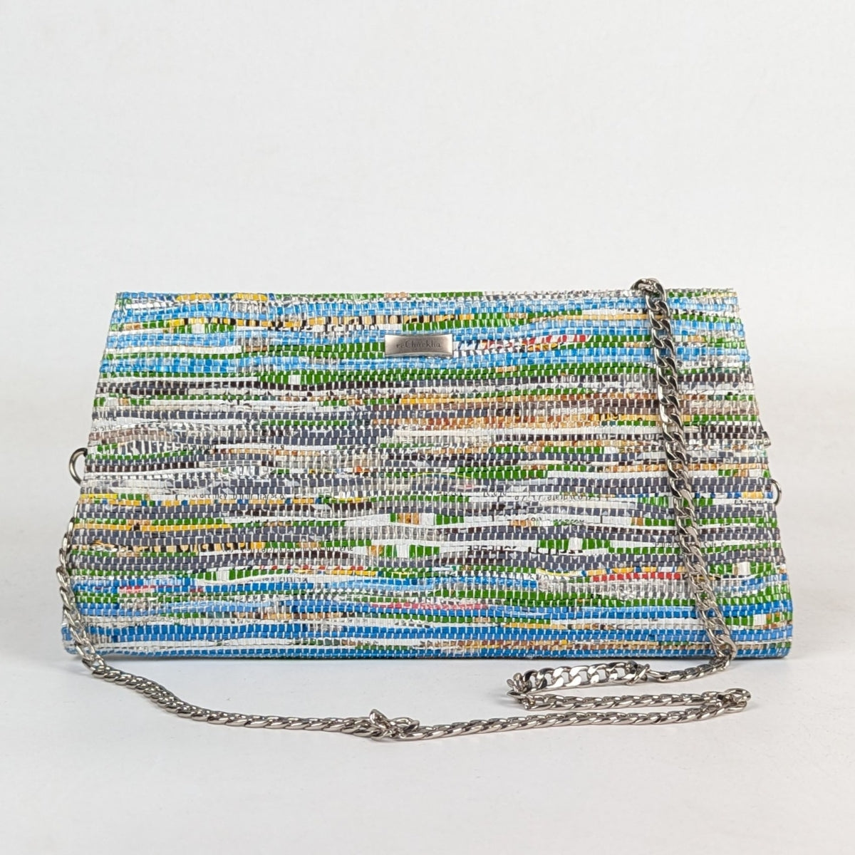 Multicolored woven handbag with a chain strap on a white background