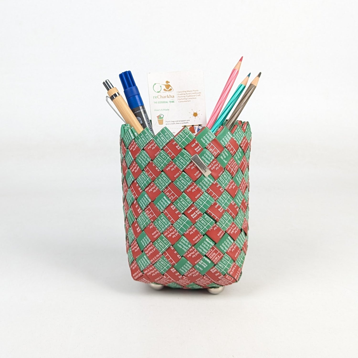 Woven pencil holder with stationery items on a white background