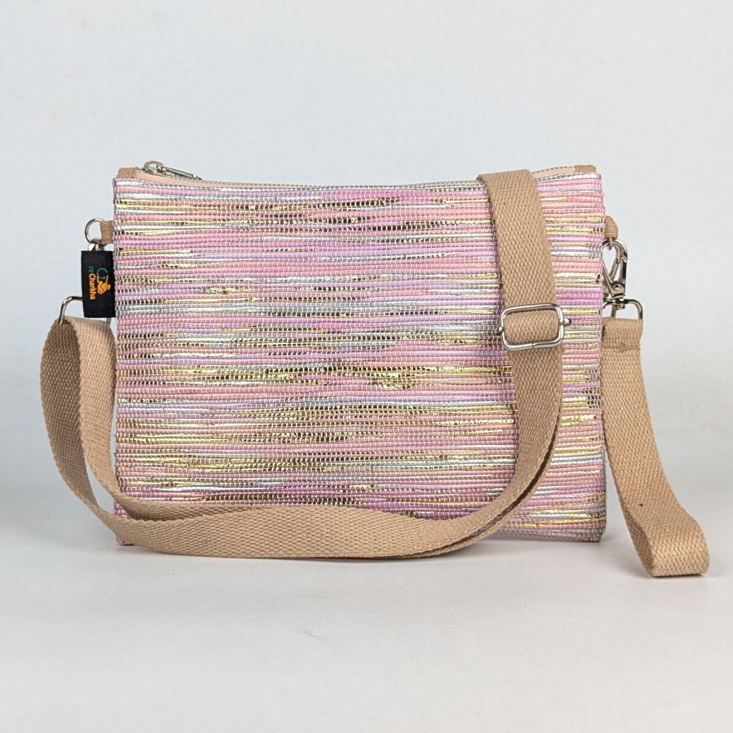 Multicolored striped handbag with beige strap on a light gray background