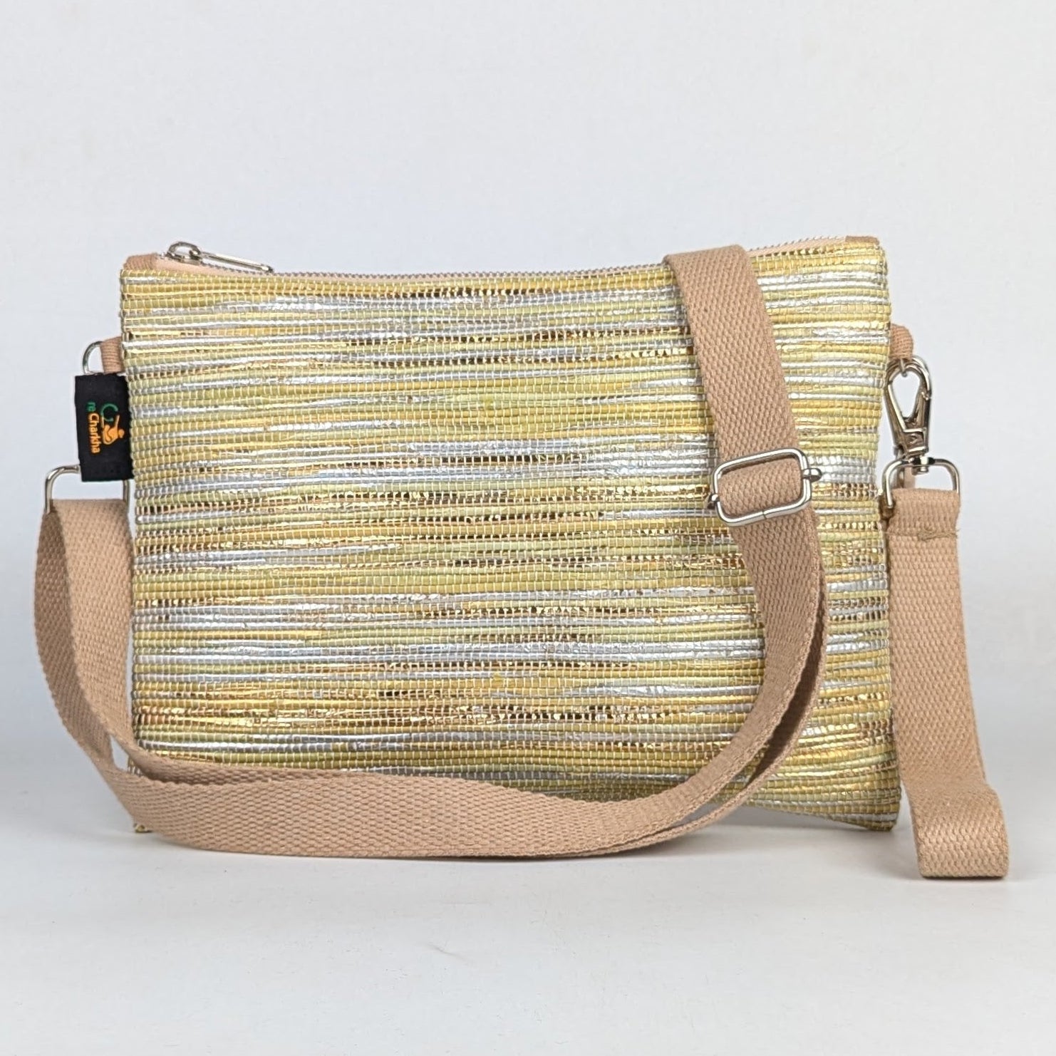 Yellow and beige crossbody bag on a light gray background