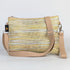 Yellow and beige crossbody bag on a light gray background